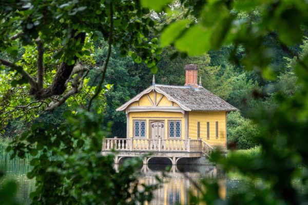 Yellow fishing lodge overlooking the lake at Belton House.