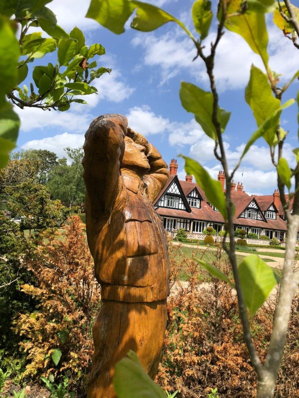 Wooden sculpture of a person looking up to the sky in the garden of the Petwood Hotel in Woodhall Spa.