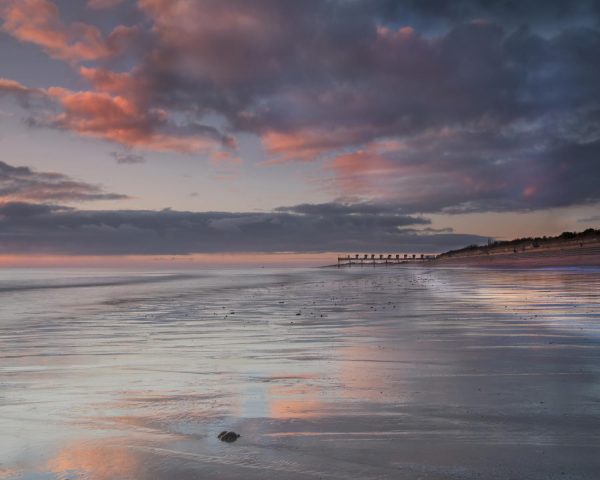 Purple and pink sunrise over the Skegness beach.